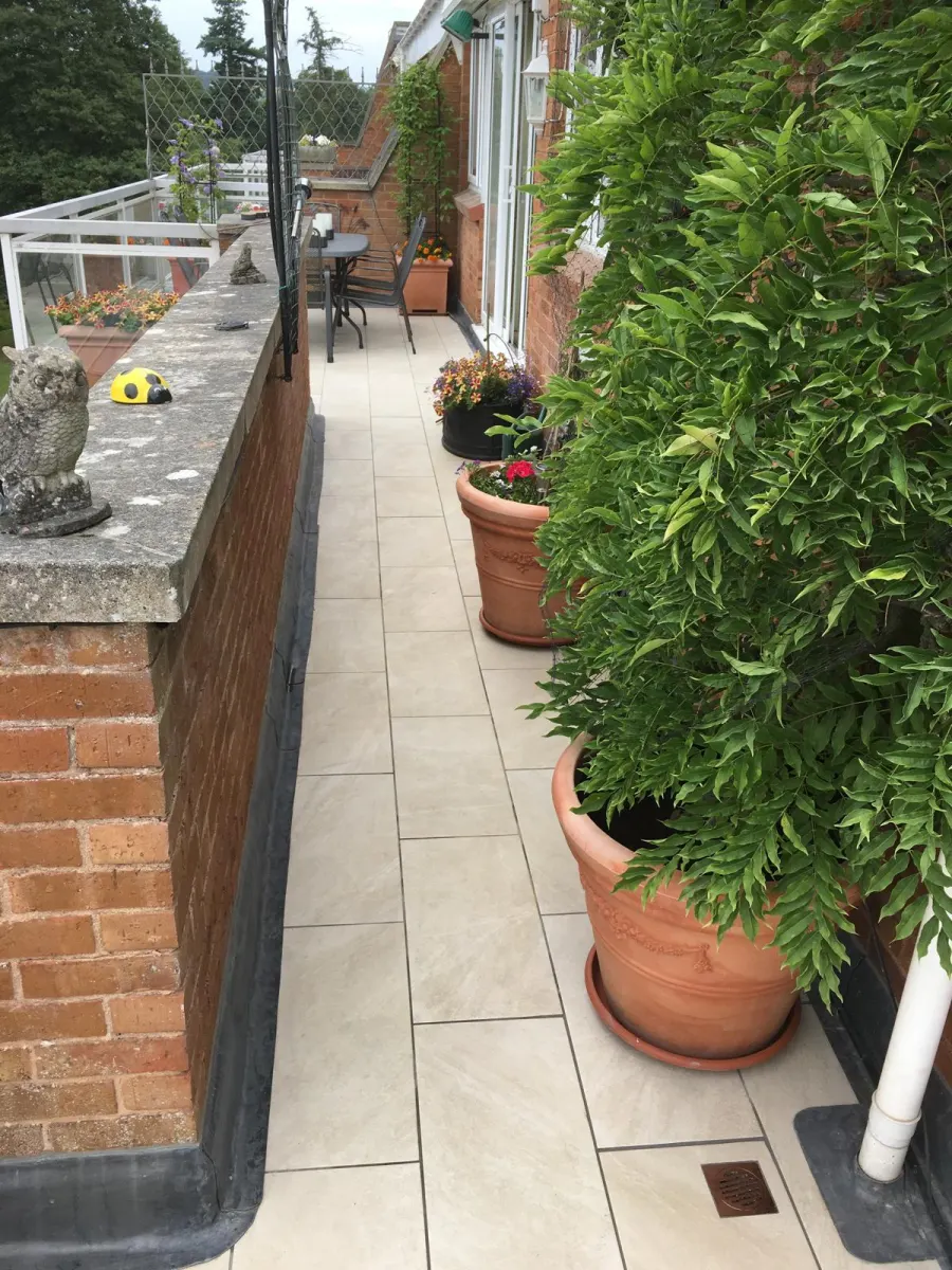 Tiled balcony flooring with terracotta planting
