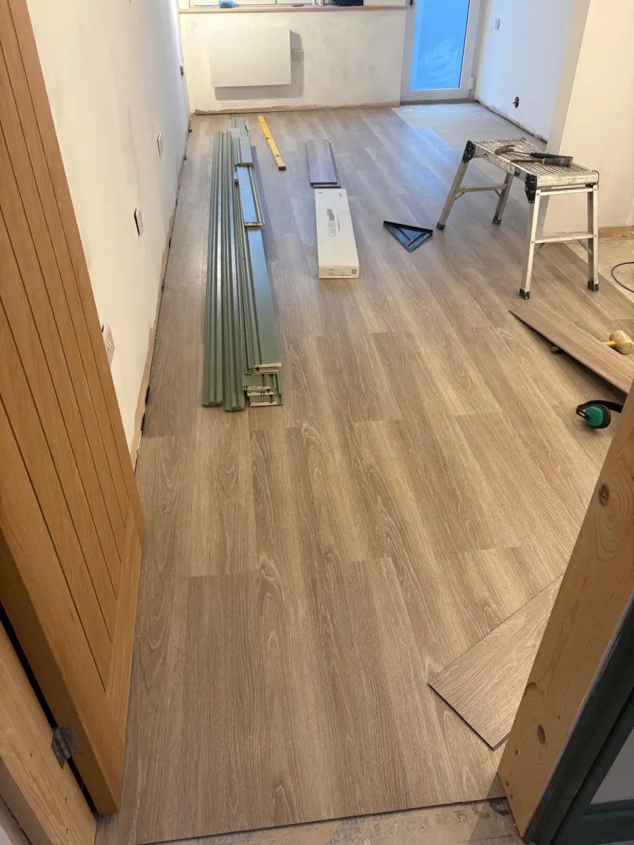 LVT flooring installation in progress in a hallway