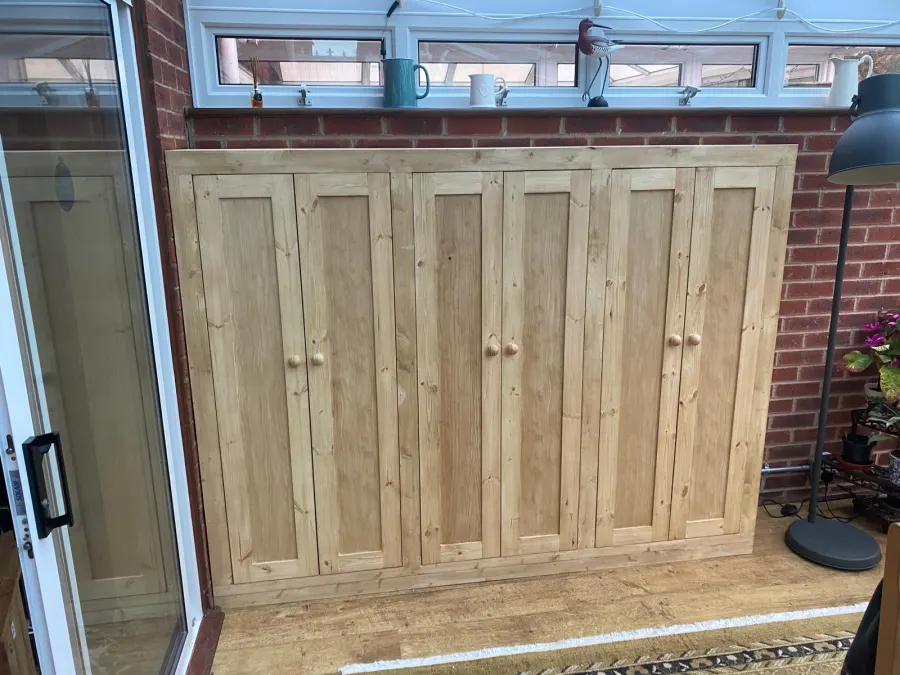 Bespoke pine storage cupboards fitted in a conservatory