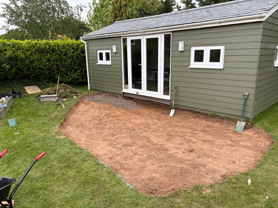 Completed garden room with bi-fold doors and stepping-stone path