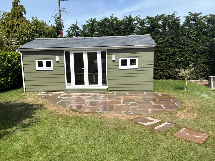 Completed timber-clad garden room with sandstone patio