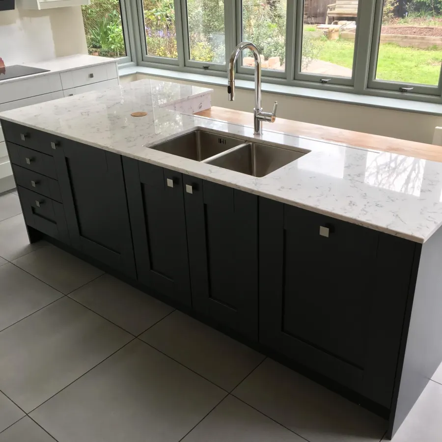 Navy kitchen island with marble-effect worktop and integrated double sink