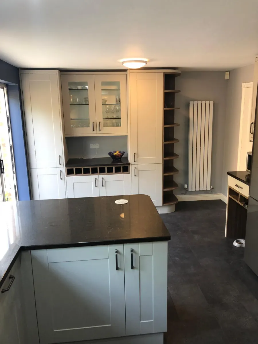 Two-tone shaker kitchen with glazed display cabinet and built-in wine rack
