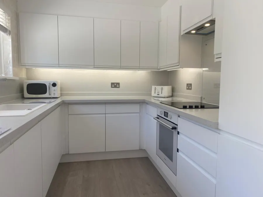 Grey handleless kitchen with integrated American-style fridge freezer
