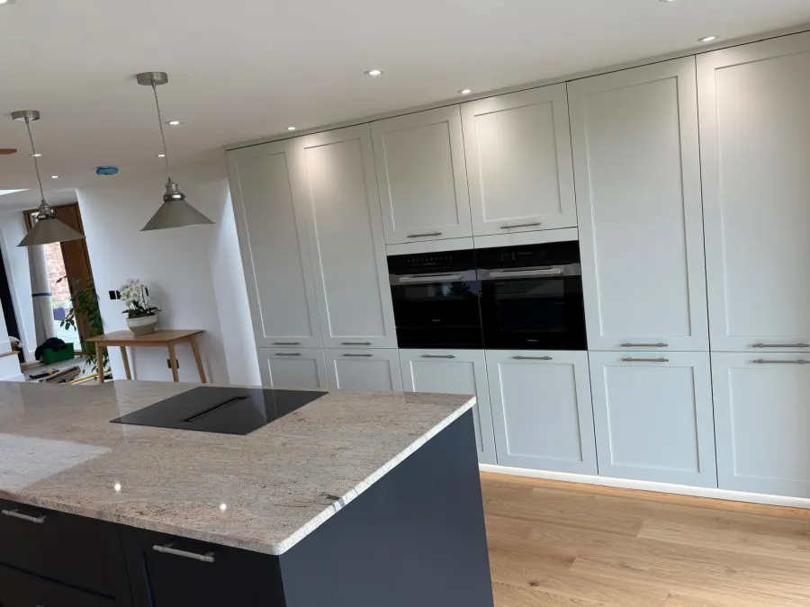 Fitted larder wall with island and pendant lighting